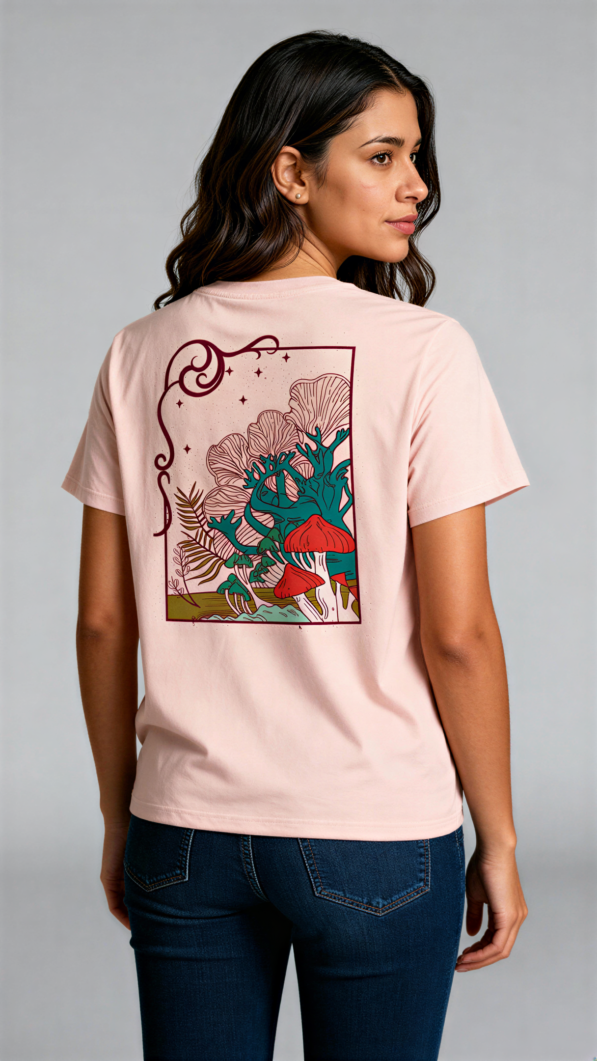 במבט מאחור, אישה לובשת חולצת כותנה אורגנית בצבע ורוד עם הדפס צבעוני של פטריות ועצים בעיצוב אמנותי מבית פיורלום.